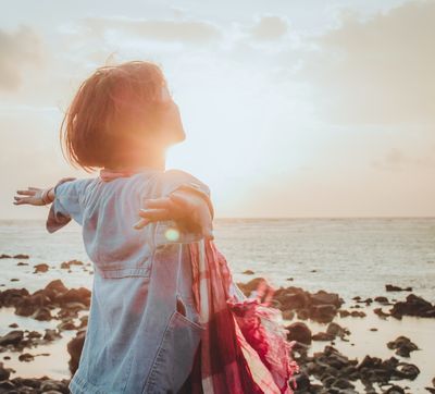 woman spreading arms in the sun